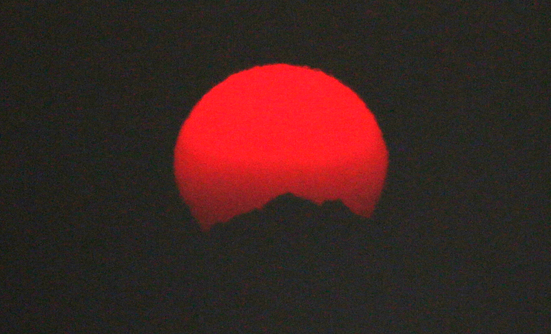 The sun sets over the Olympic Mountains, made a brilliant red because of smoke from fires raging in British Columbia that swept down into the Puget Sound region, Wednesday, Aug. 2, 2017, in Seattle. AP Images